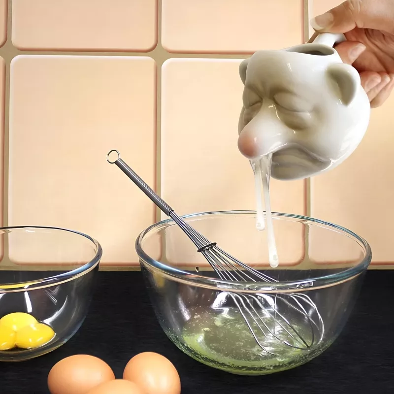 Egg separator pouring whites into a bowl.