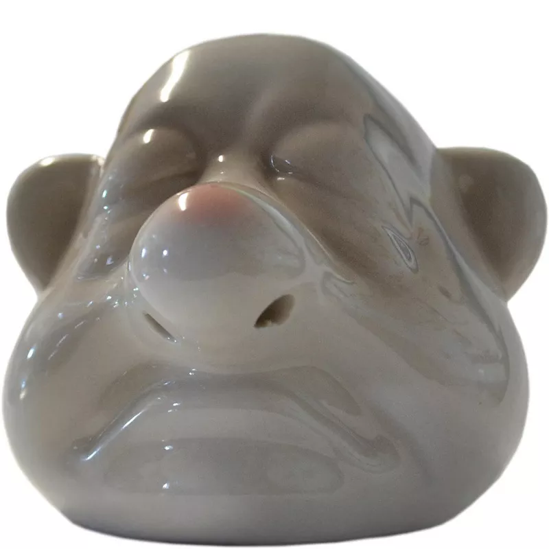 Ceramic face pot with closed eyes and nose