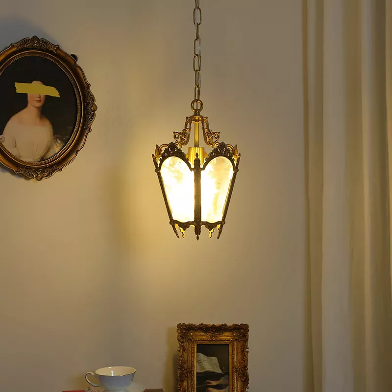 Vintage pendant light with antique portrait on wall