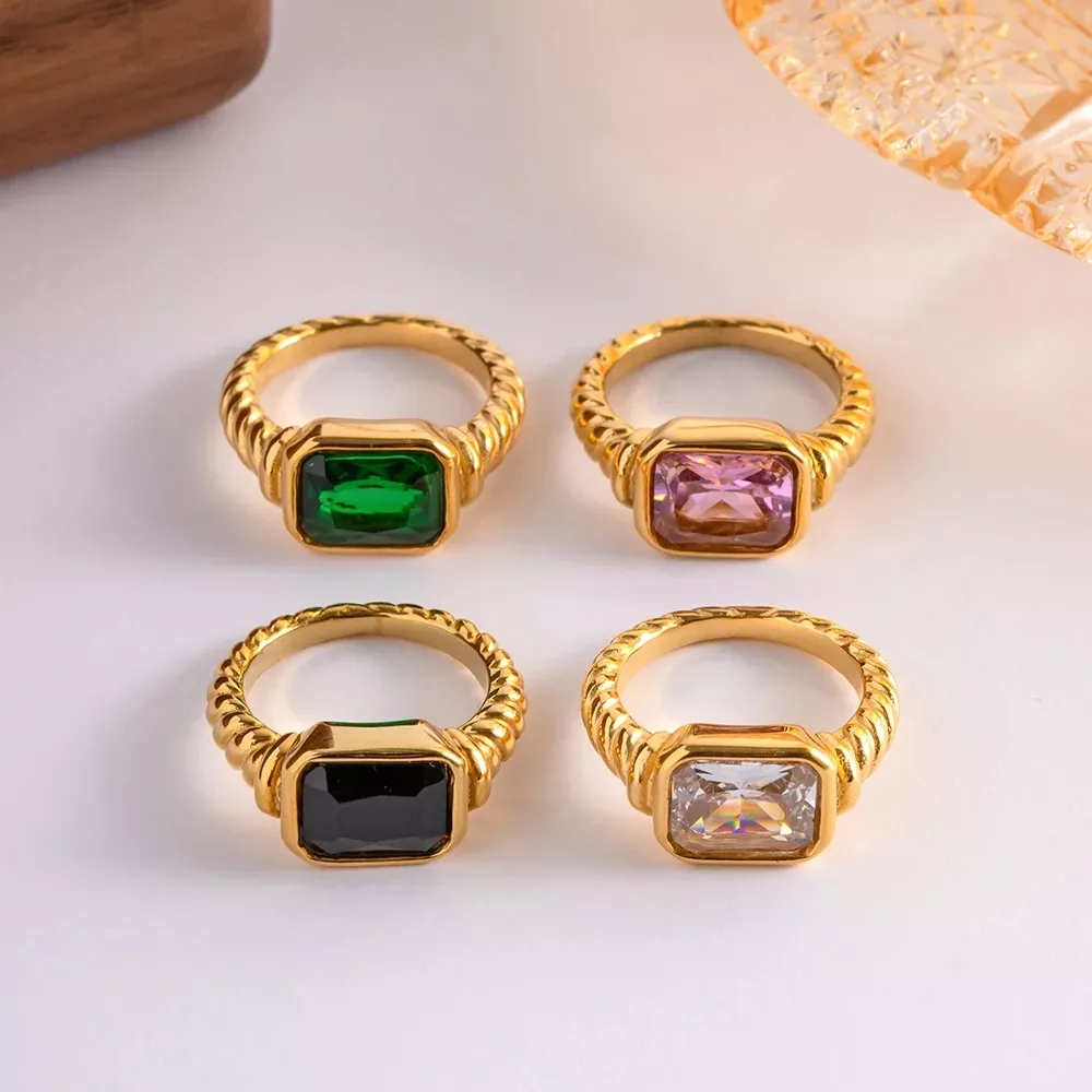Four gold rings with colorful gemstones