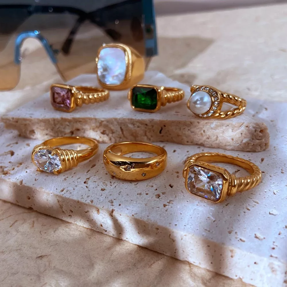 Assorted gold rings with gemstones on display.