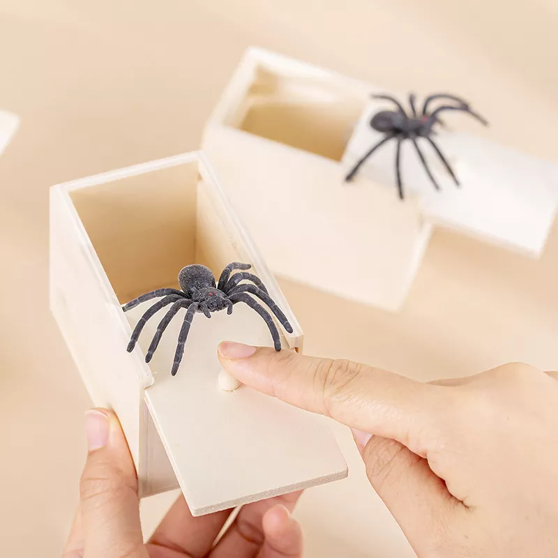 Wooden prank box with fake spider jumps out.