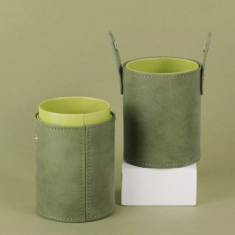 Green suede cylindrical containers on display