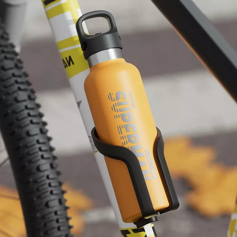 Orange bottle in bike holder, close-up view.