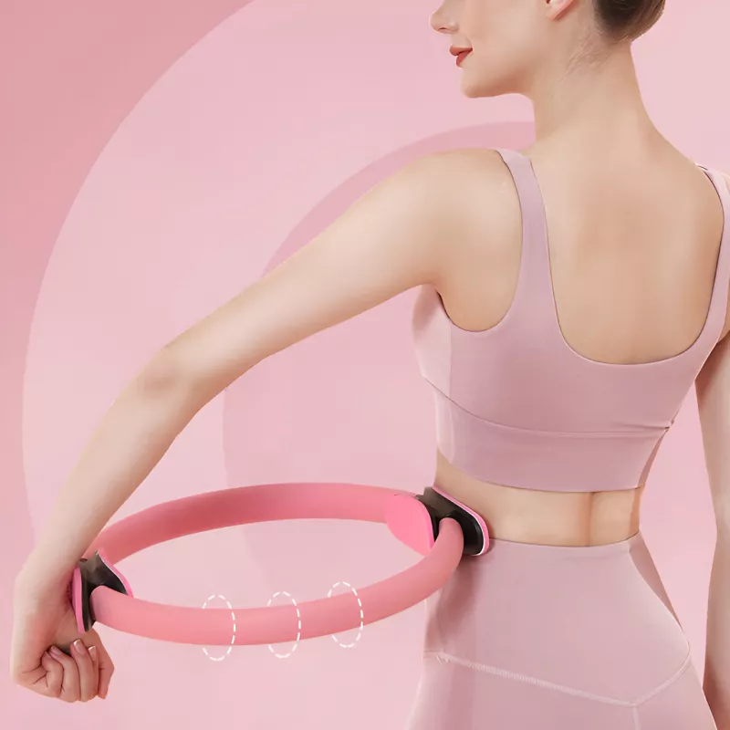 Woman exercising with pink Pilates ring