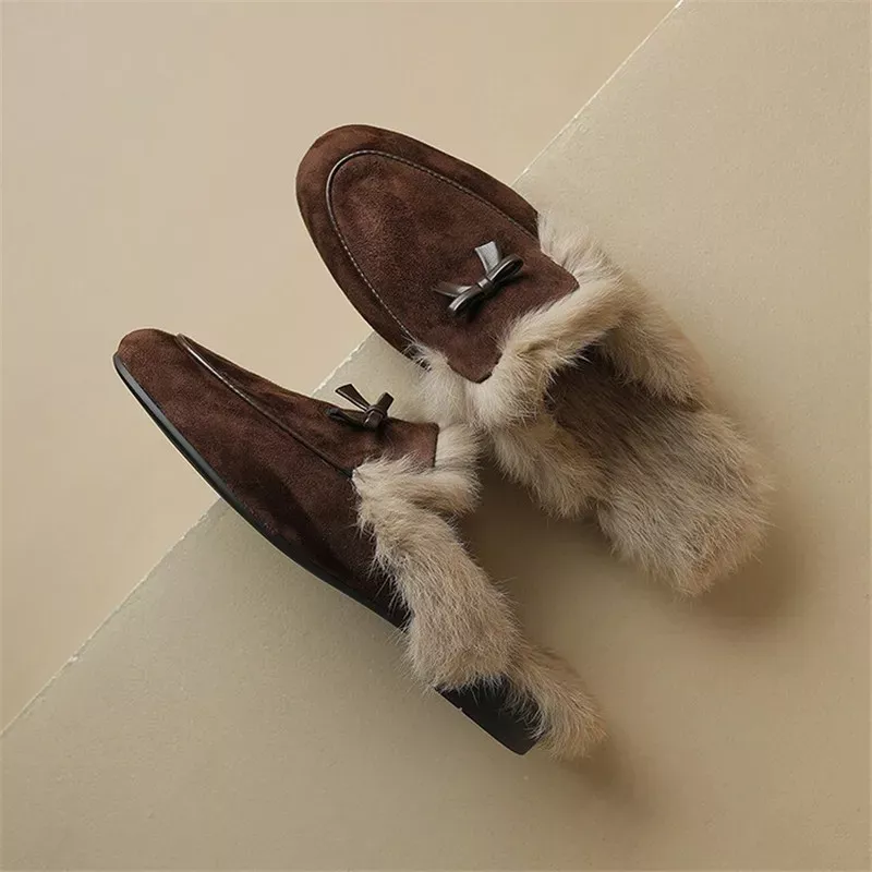 Brown fur-lined suede loafers with bows